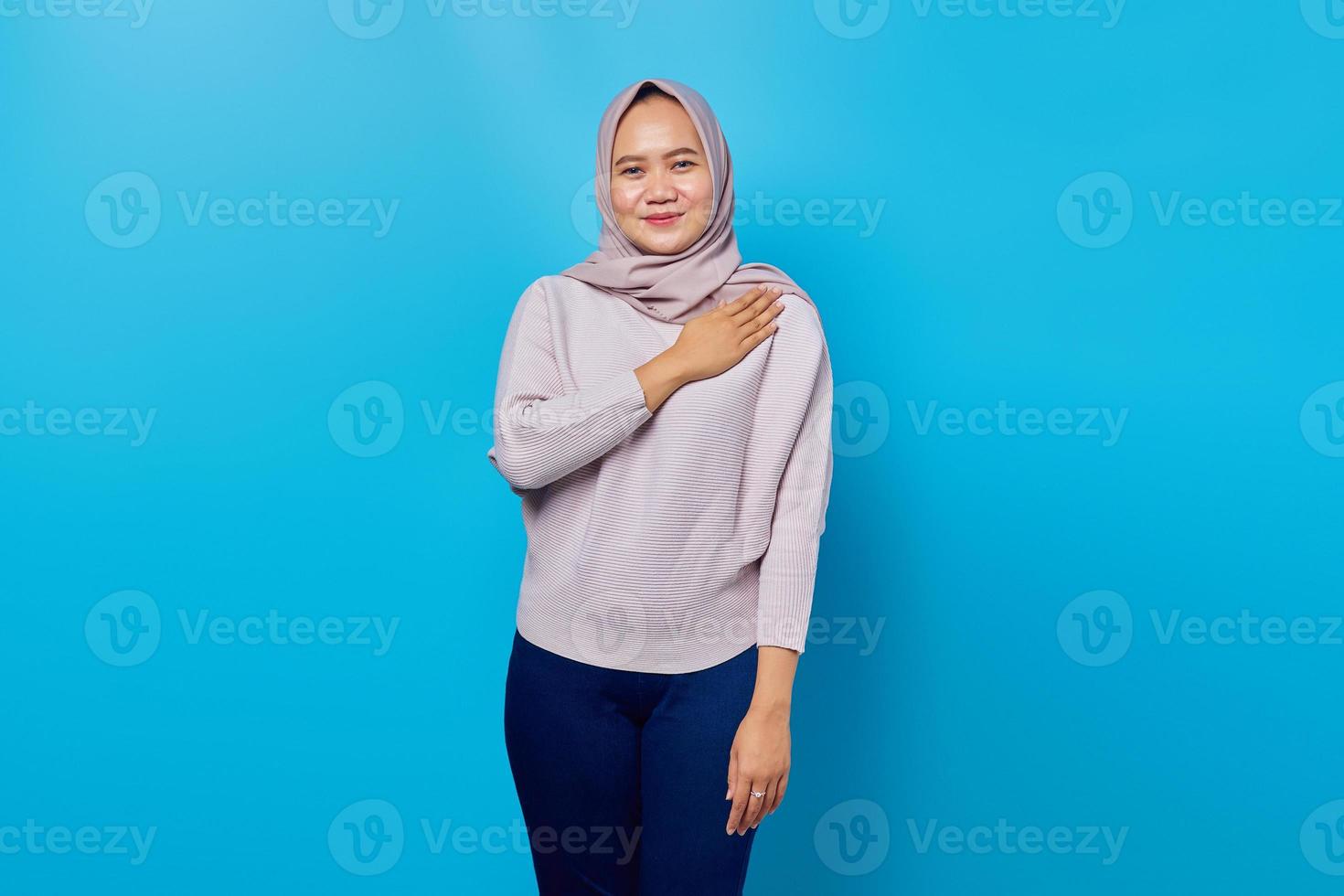 Portrait of smiling asian woman customer support over blue background photo