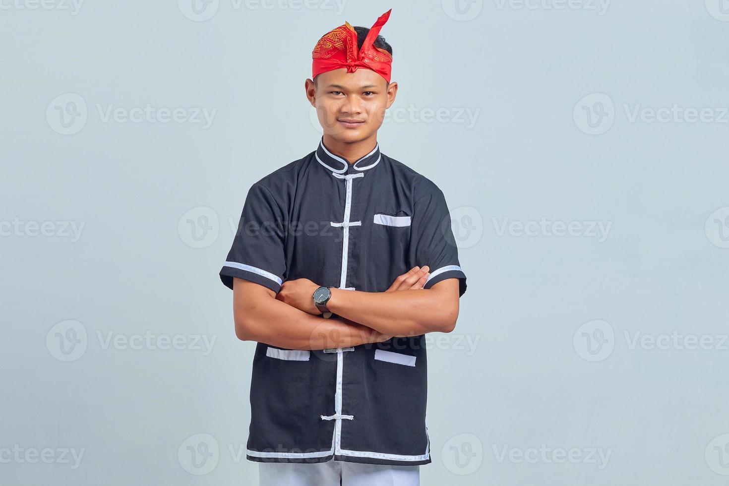 Handsome young karate sportsman in kimono makes position to start practice photo