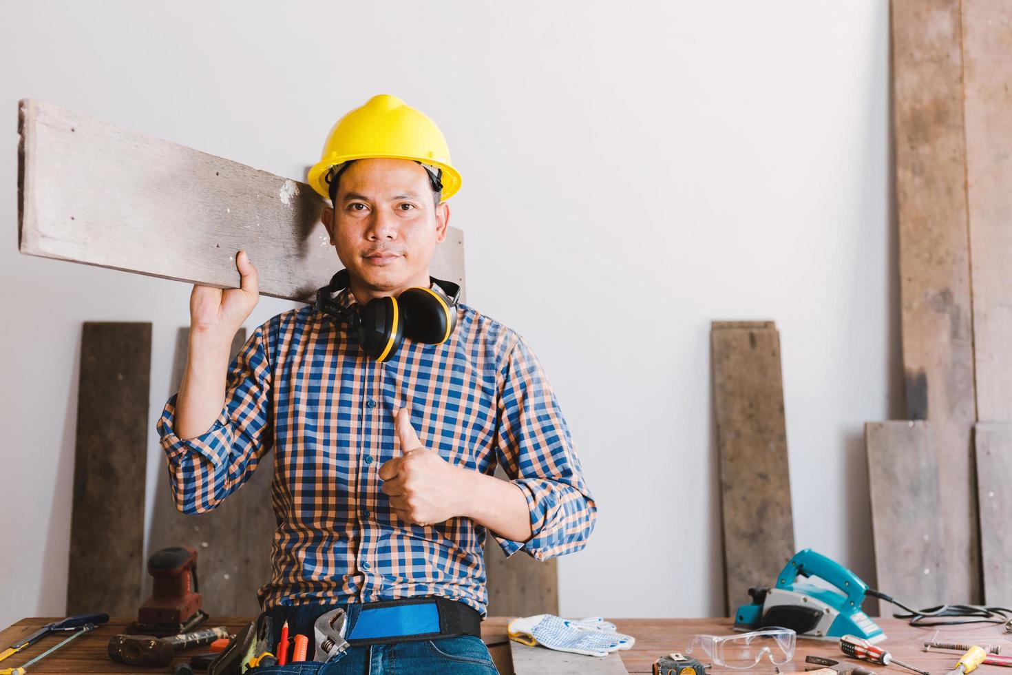 Carpenter working on woodworking machines in carpentry shop. photo