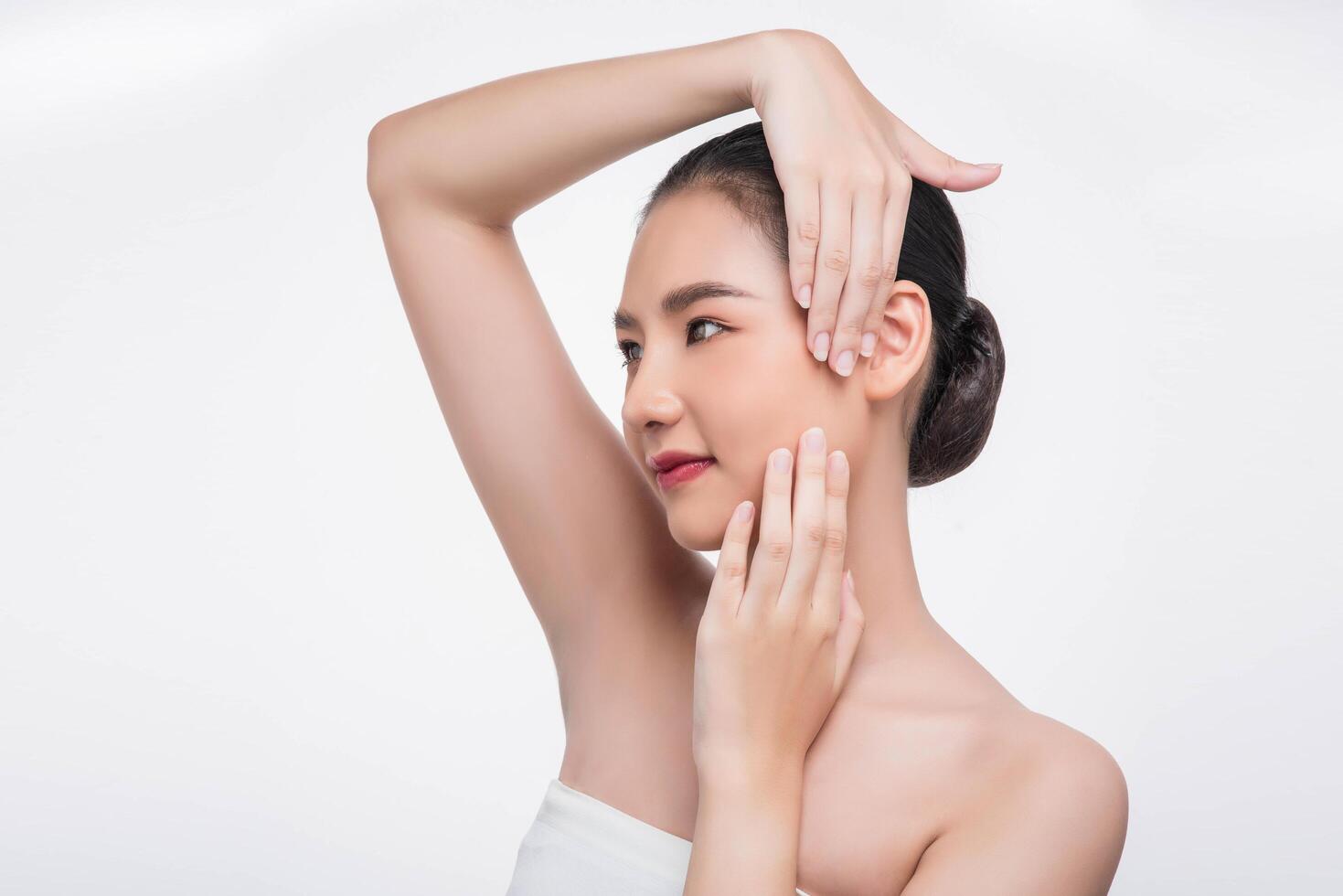 Beautiful woman, good looking face, touch her face. photo