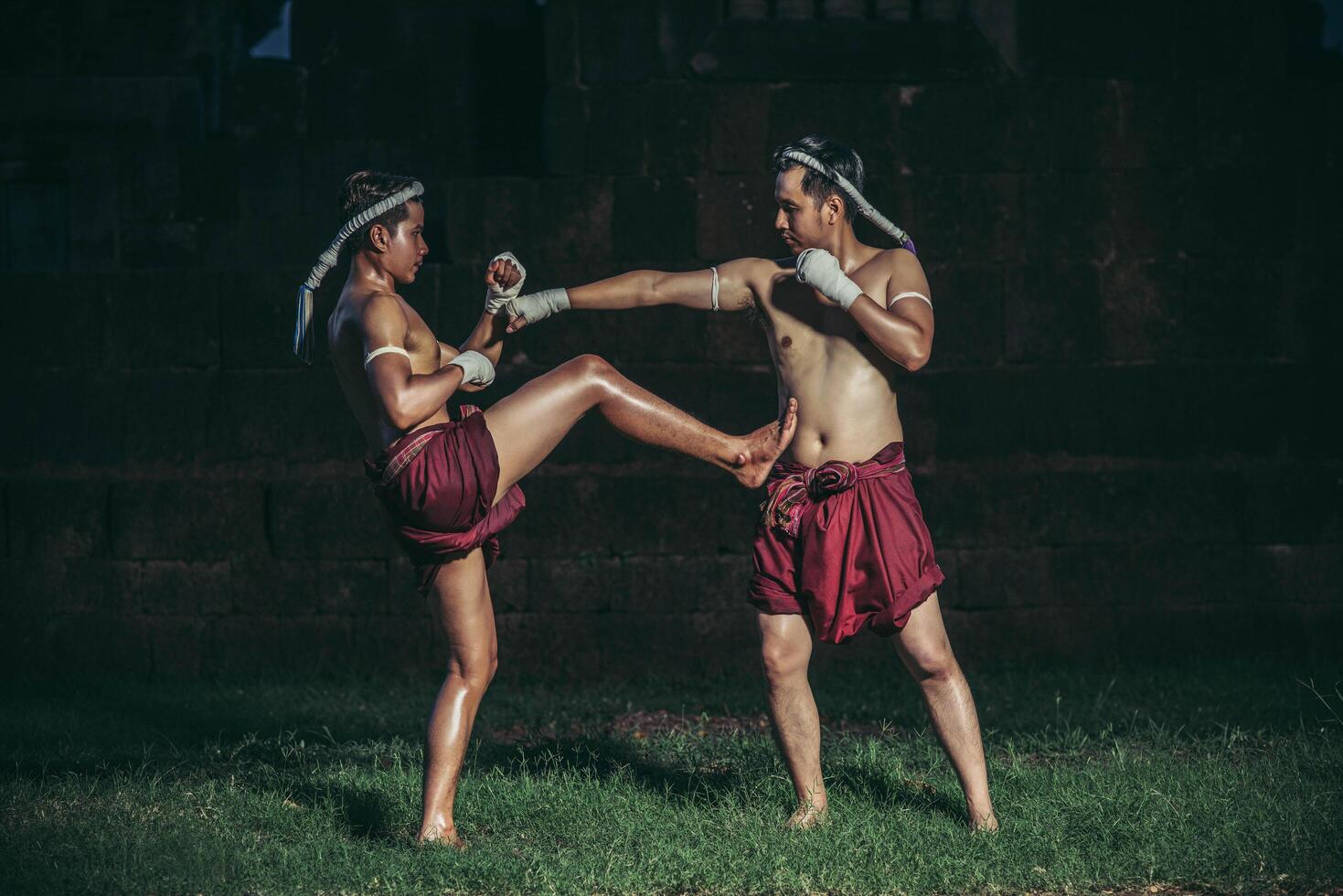 Two boxers fight with the martial arts of Muay Thai. photo