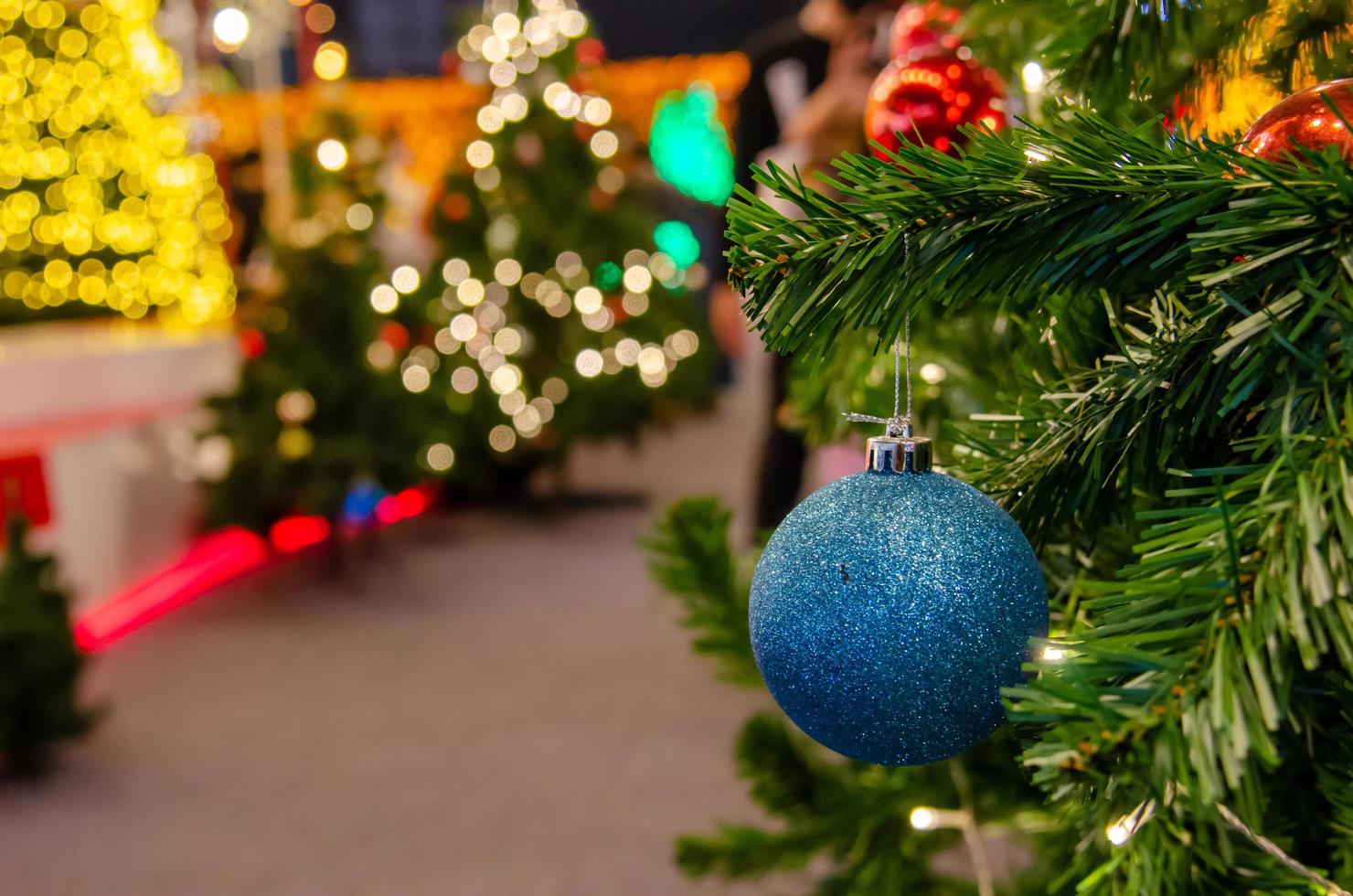 Blue balls decorated with Christmas tree decorations. New year and Christmas festivals. Copy space background. photo