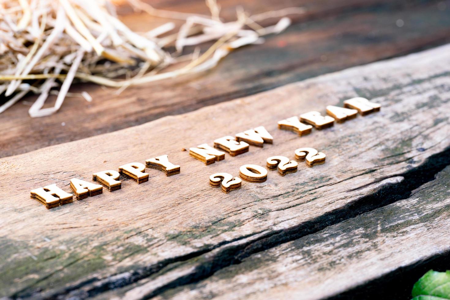 Wood text HAPPY NEW YEAR 2022. On broken wooden plank. Retro style. photo