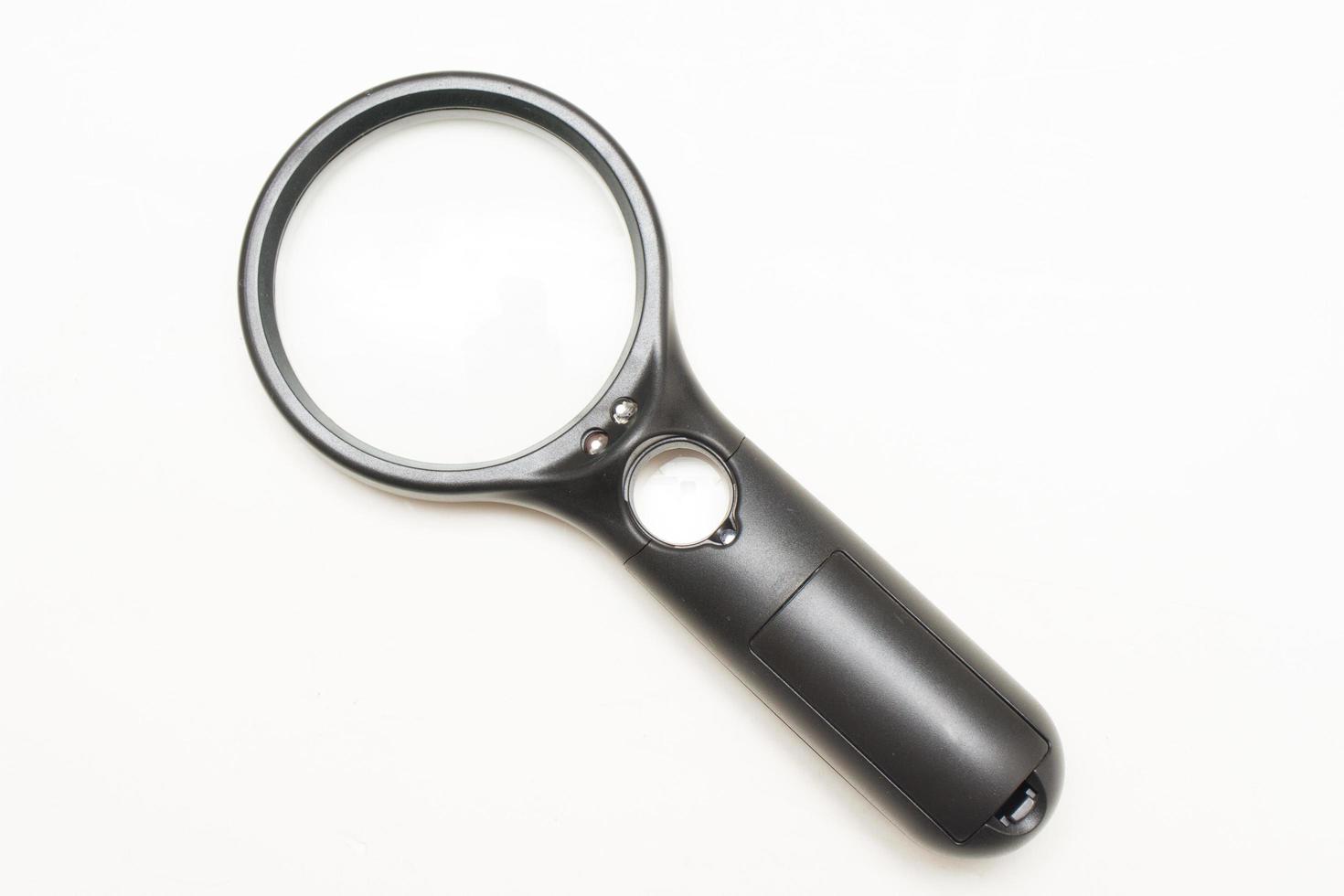 A black magnifying glass with an optical magnifier on a white background photo