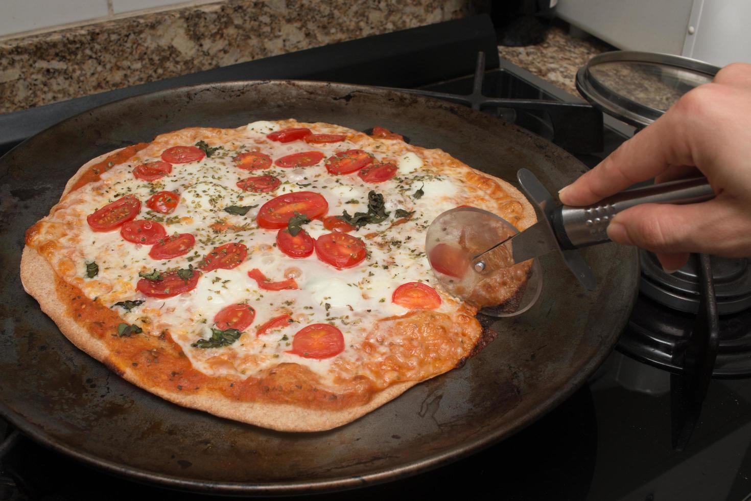 Delicious Homemade Pizza Margherita Ready to be Sliced and eaten photo