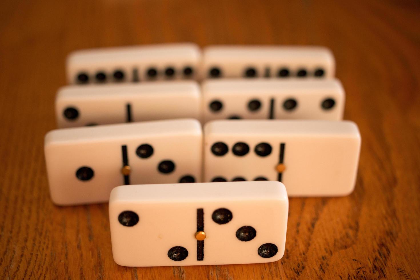 Playing the game of Dominoes on a wooded table photo