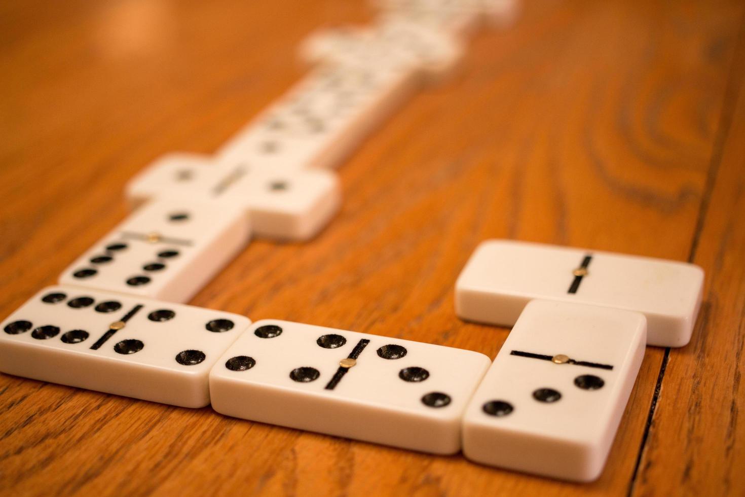 Playing the game of Dominoes on a wooded table photo