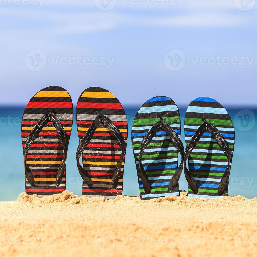 Flip flops on the sandy beach photo