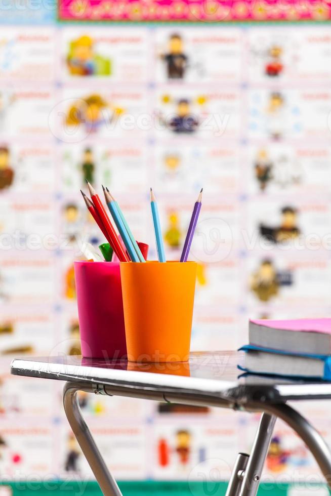 Pencils and book on table photo