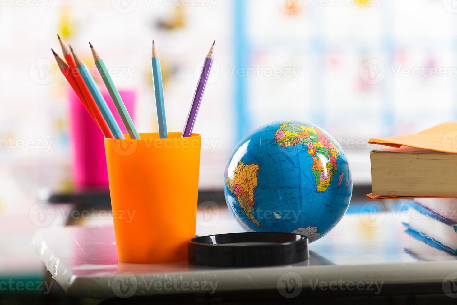 Pencils and book on table photo