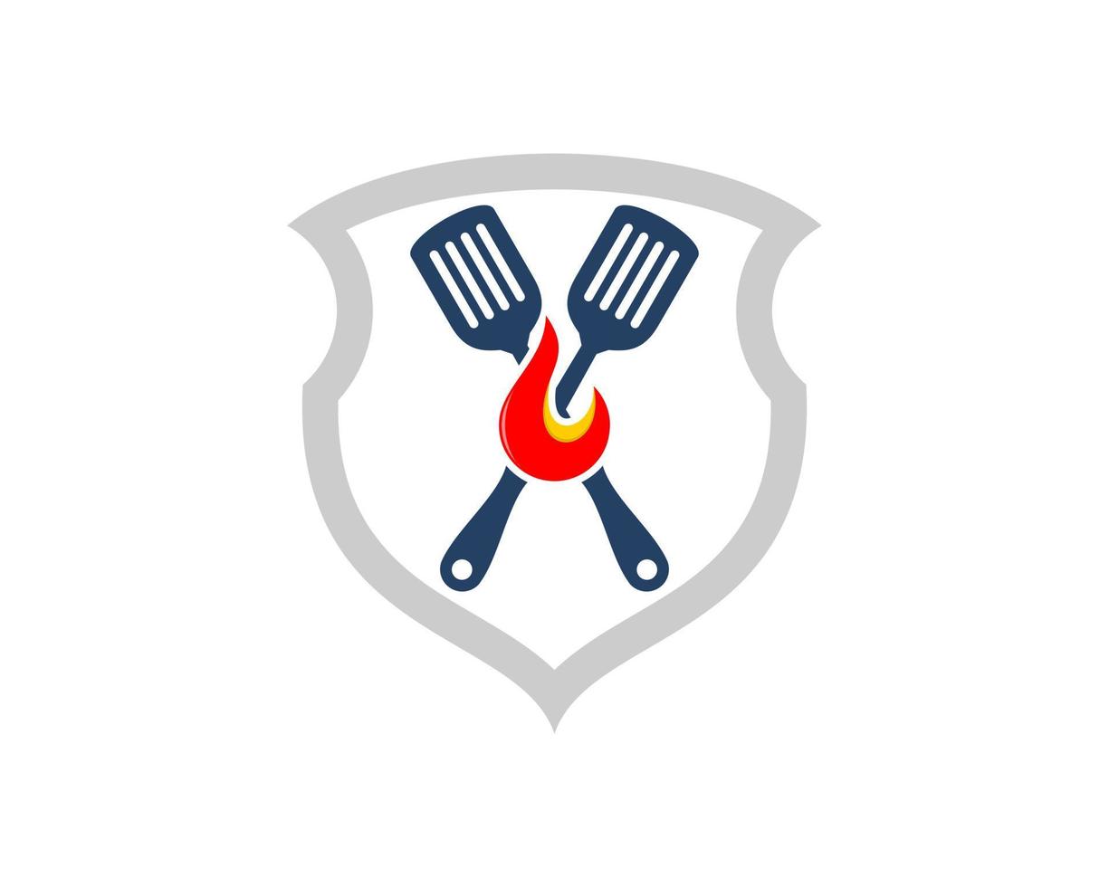 Abstract shield with cross spatula and fire inside vector