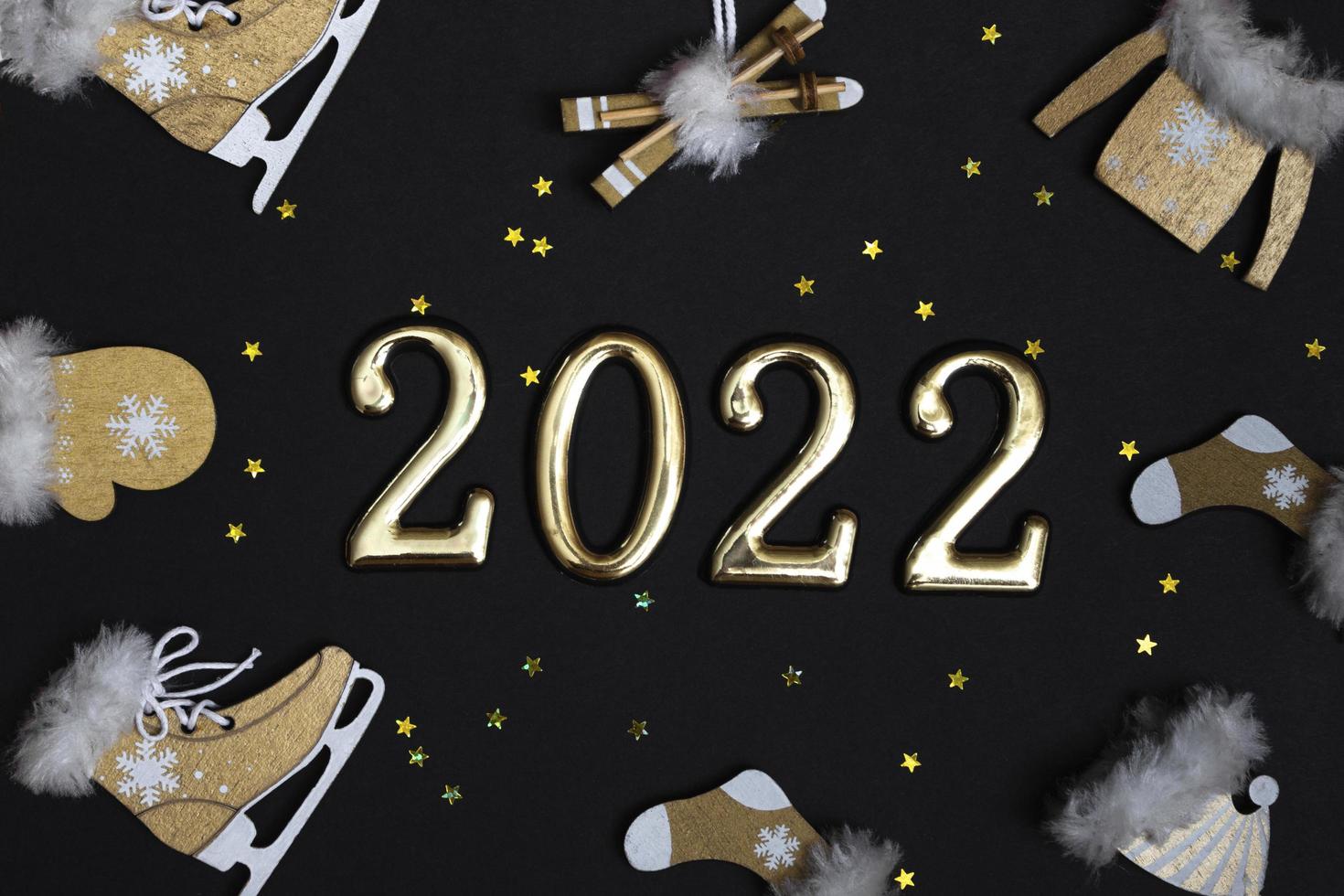 Top view flat New Year mockup on black background with numbers and New Year decor. New Year 2022, with copy space photo