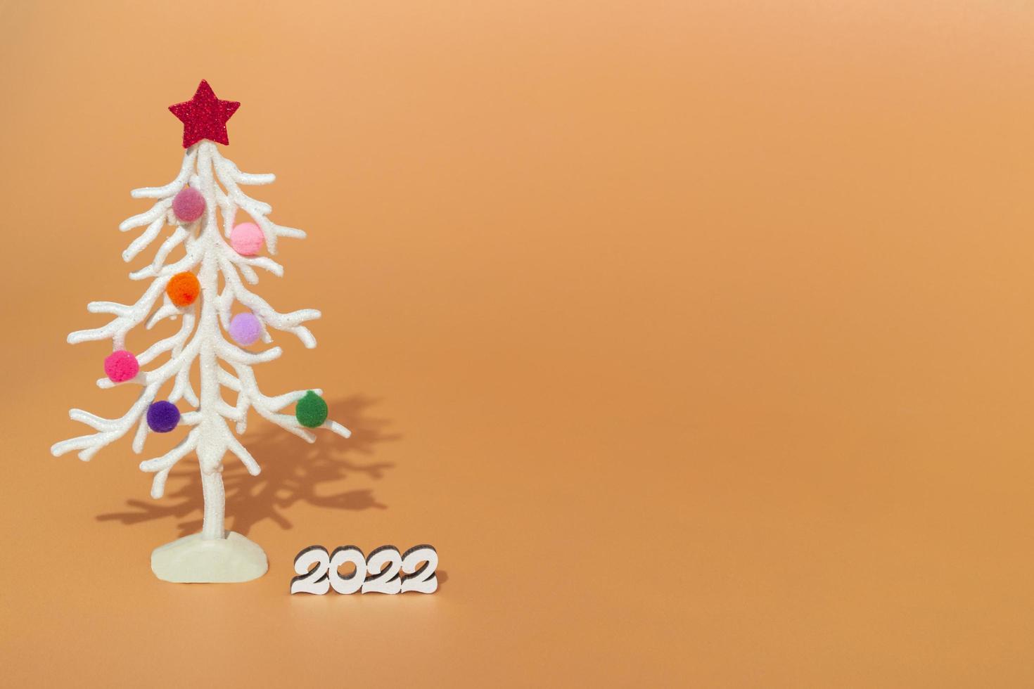 Christmas Card. Against The Background Of Christmas Lights, A White Christmas Tree In Multi-Colored Fur Toys With The Numbers 2022. Copy Space 4823331 Stock Photo At Vecteezy