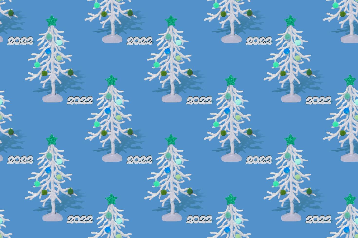 Christmas background, white fir tree with white numbers 2022. Seamless pattern on a colored background. photo