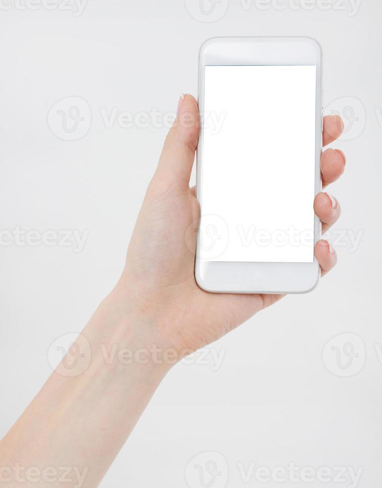 woman shows blank display of mobile phone, hand points to device, blank screen cellular photo