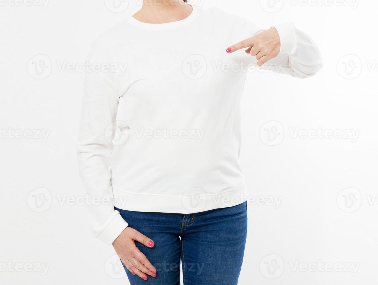 White long sleeve t-shirt on a middle aged woman in jeans and pointed hand isolated, front , mockup cropped image photo