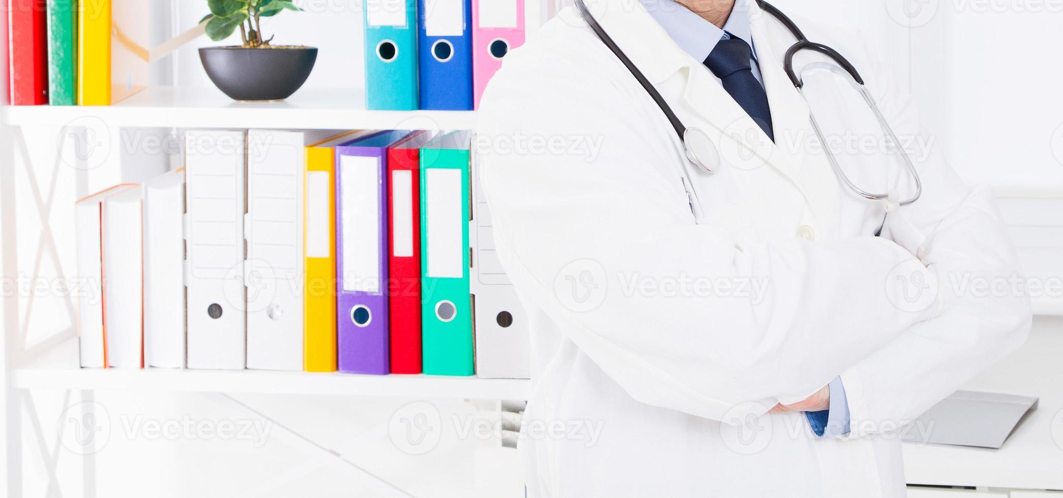 Portrait of senior doctor in medical office photo