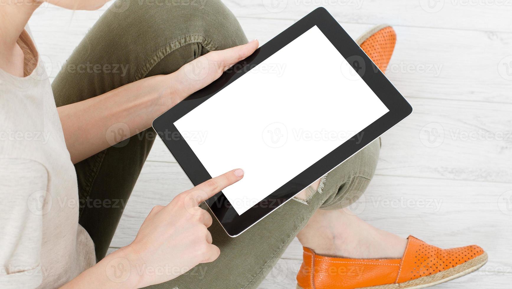 woman using tablet and touching blank display at home, hand device photo