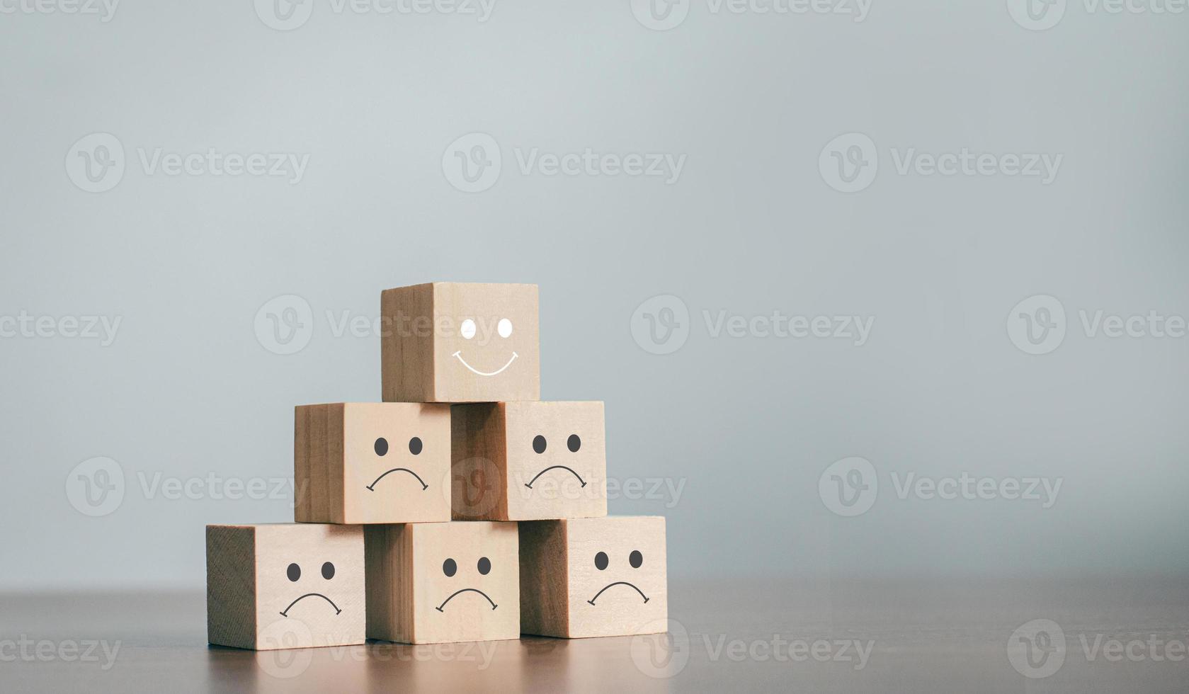 The best business services rate the customer experience. sorted by service level Satisfaction Survey Concept With a business wooden block, choose a smiley face on the top wooden block. photo