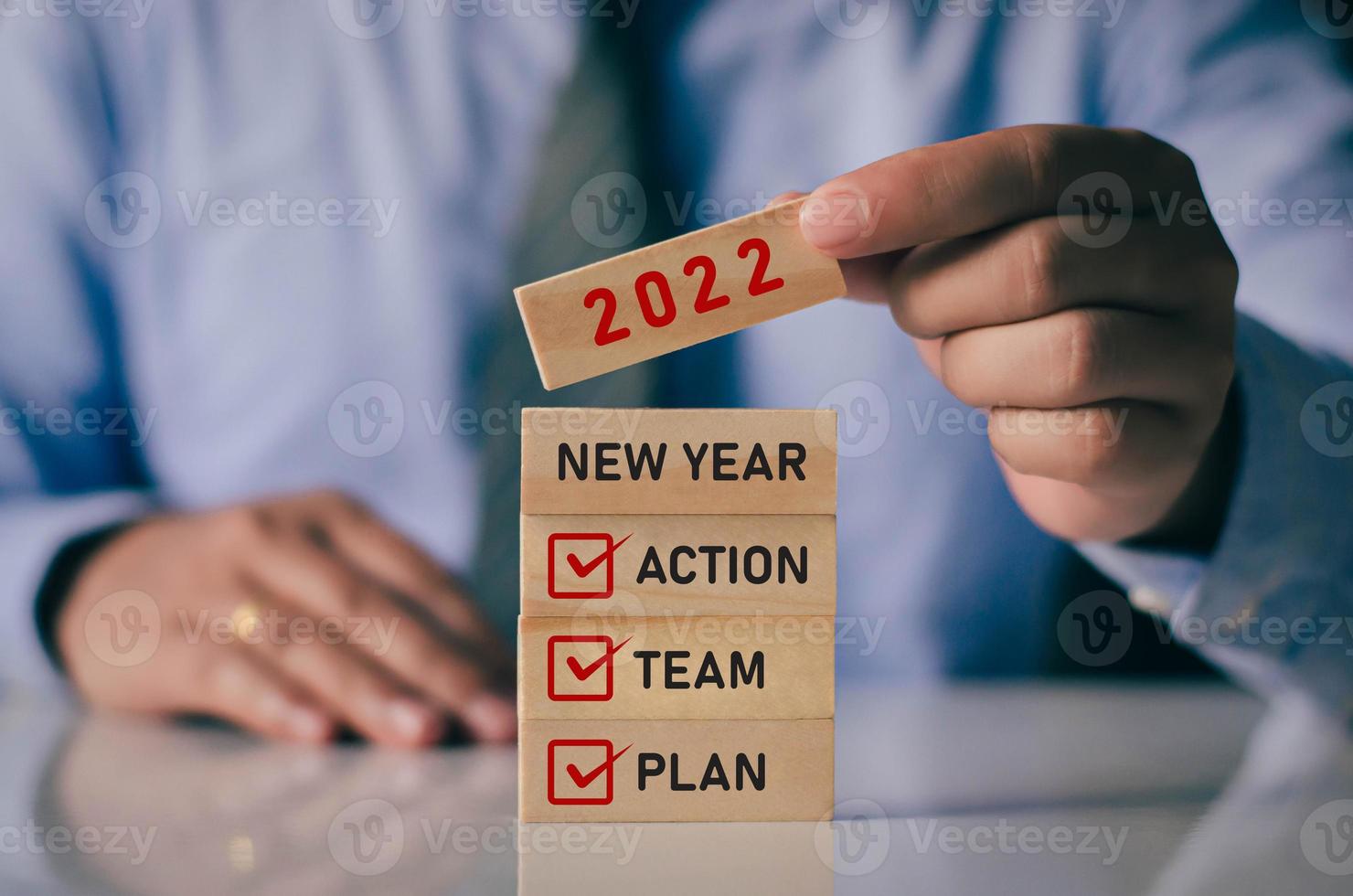 Businessman laying wooden blocks lined up. New year 2022 business planning idea. along with the steps of the business idea photo