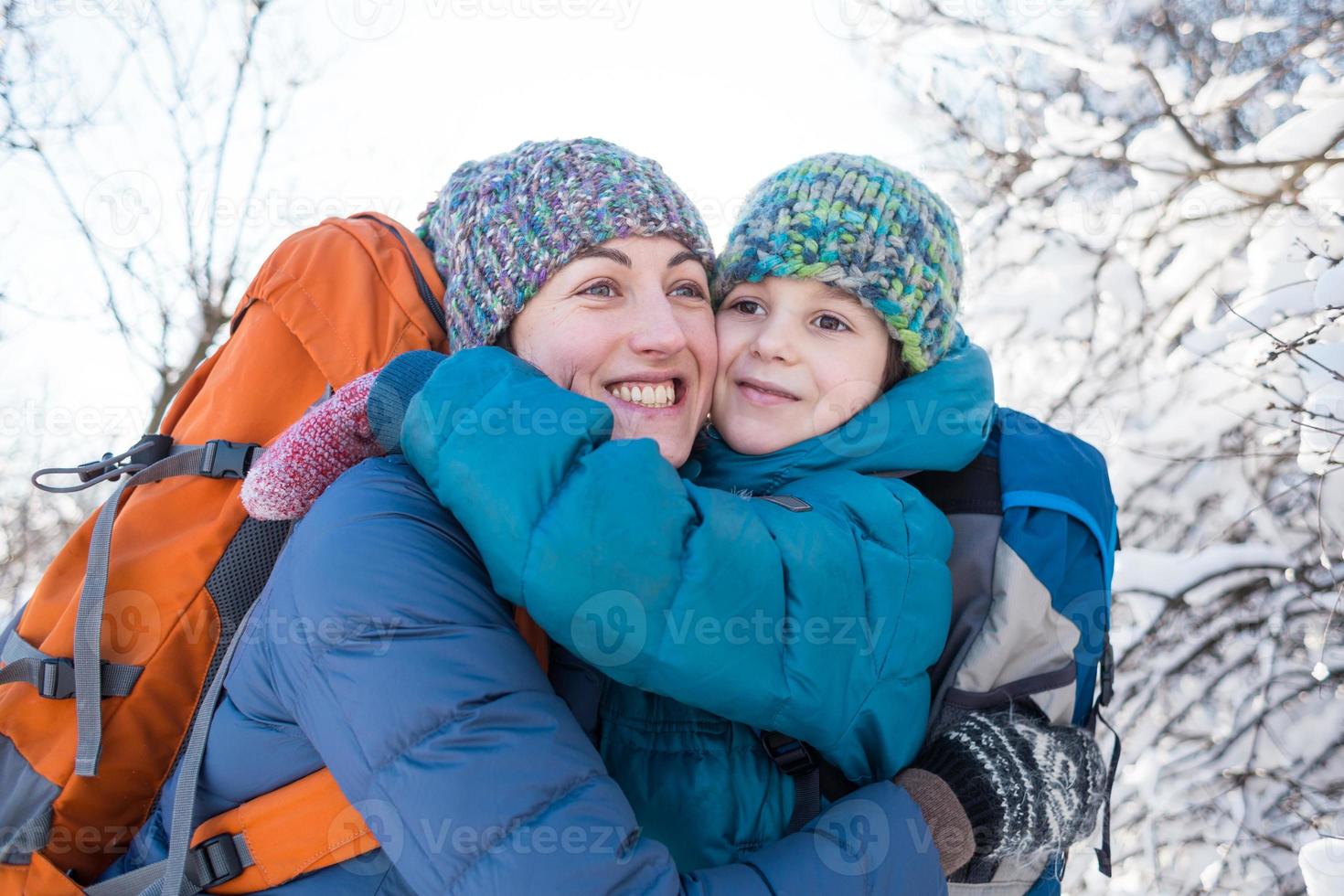 Mom kisses and hugs her son. photo