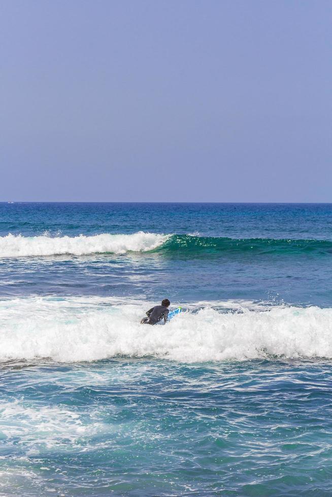 Surfer in waves Playa del Camison Canary Spanish island Tenerife. photo