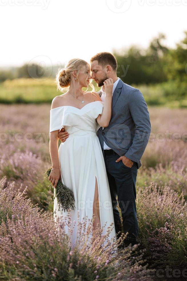 bride and groom on in the lavender field photo