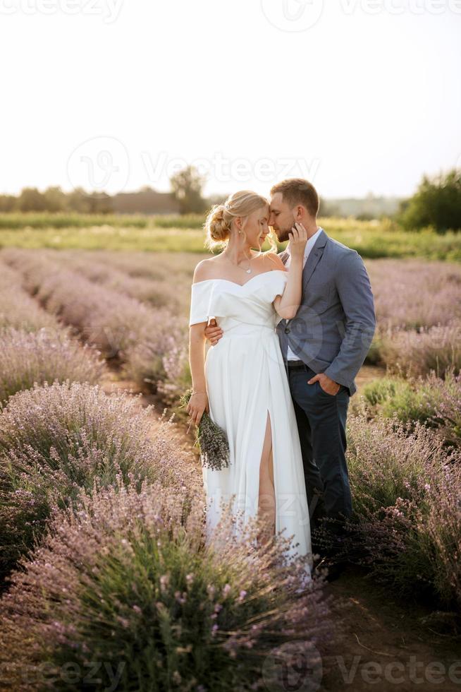 bride and groom on in the lavender field photo