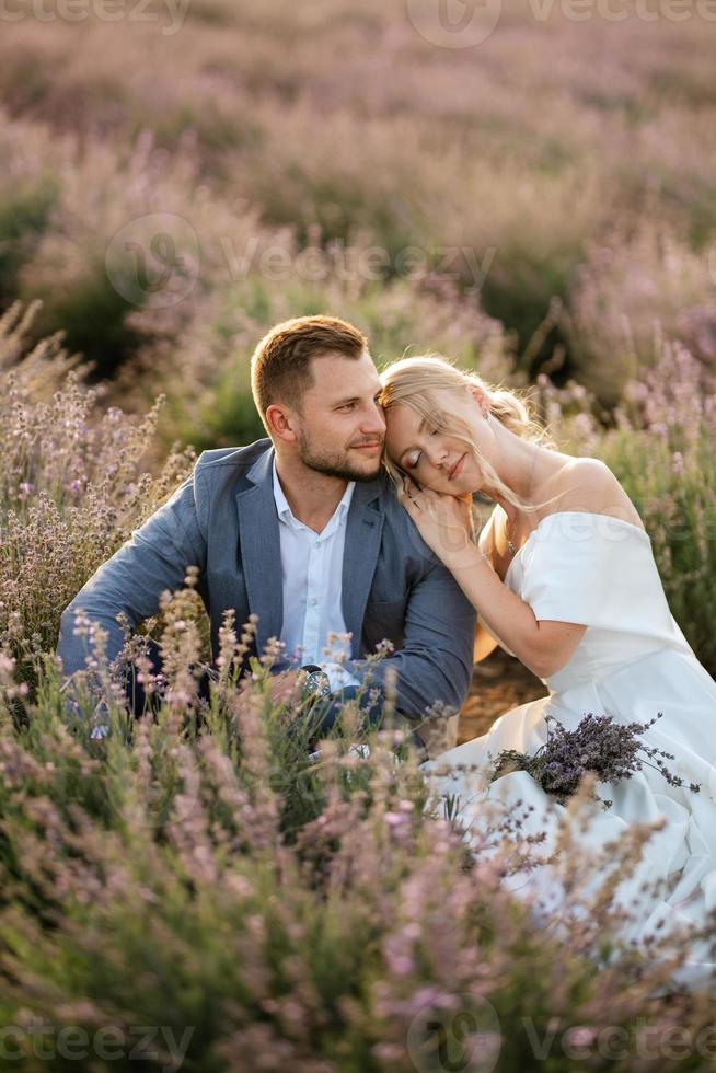 bride and groom on in the lavender field photo