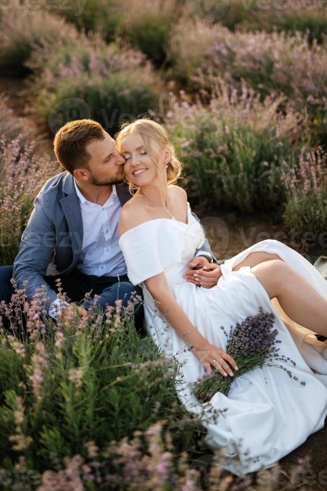 bride and groom on in the lavender field photo