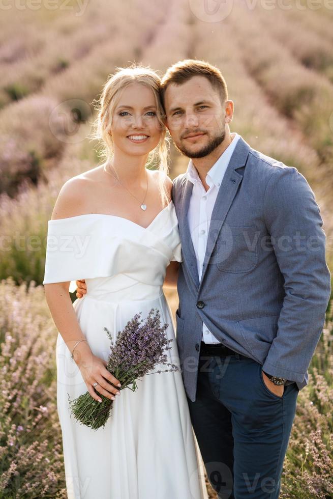 bride and groom on in the lavender field photo