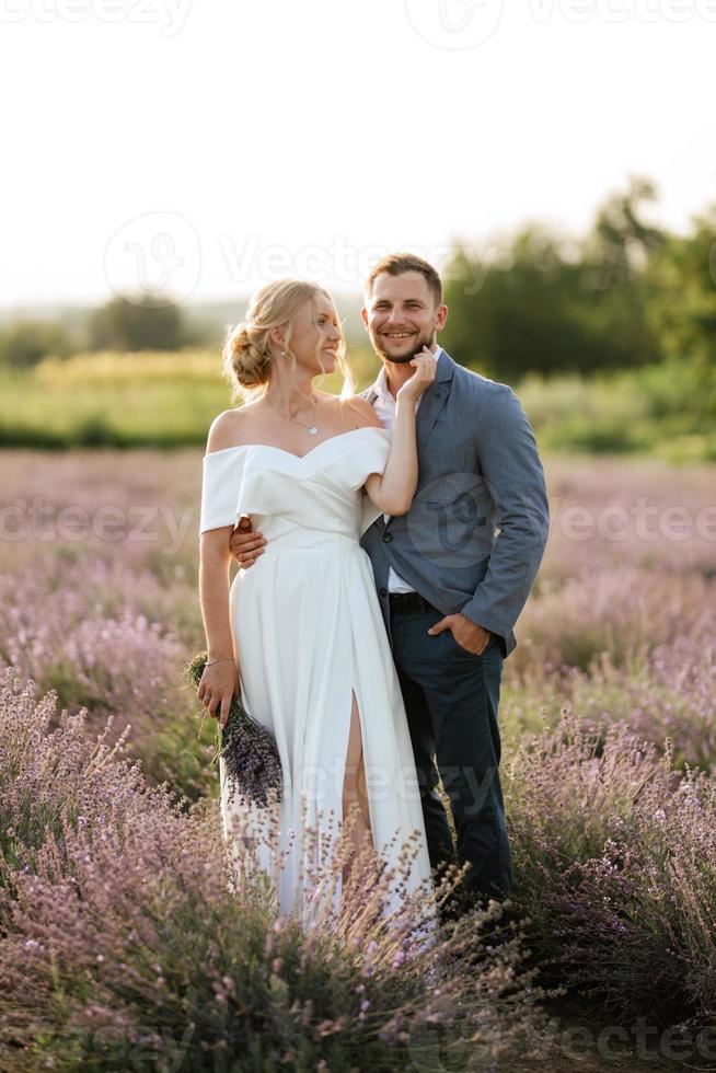 bride and groom on in the lavender field photo