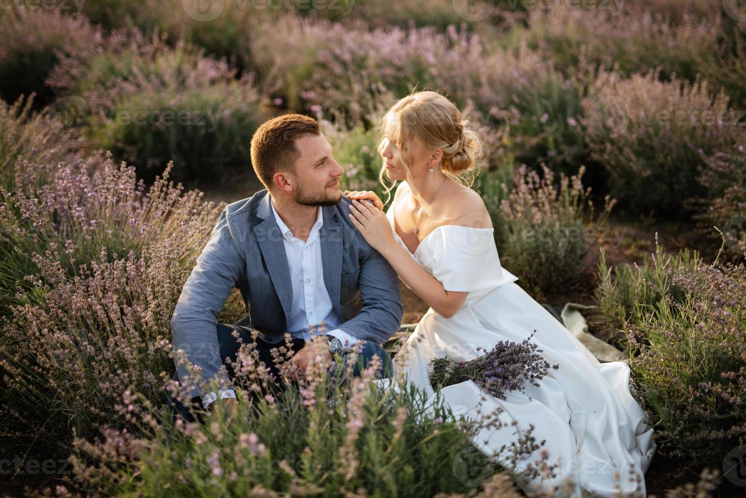 bride and groom on in the lavender field photo