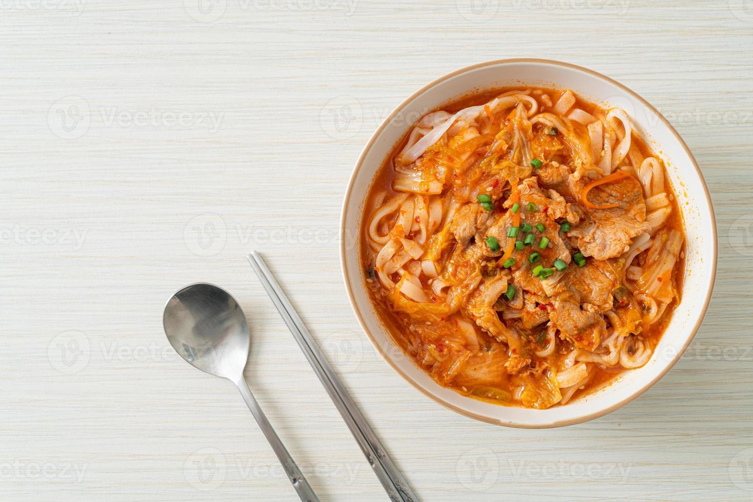 Korean udon ramen noodles with pork in kimchi soup photo