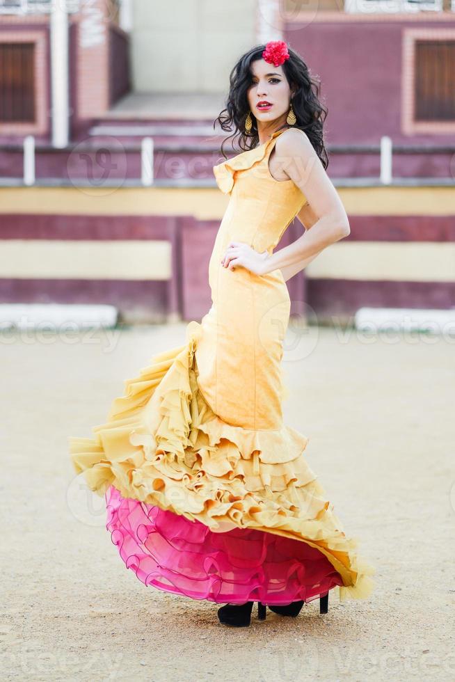 Woman, model of fashion, wearing a dress in a bullring photo