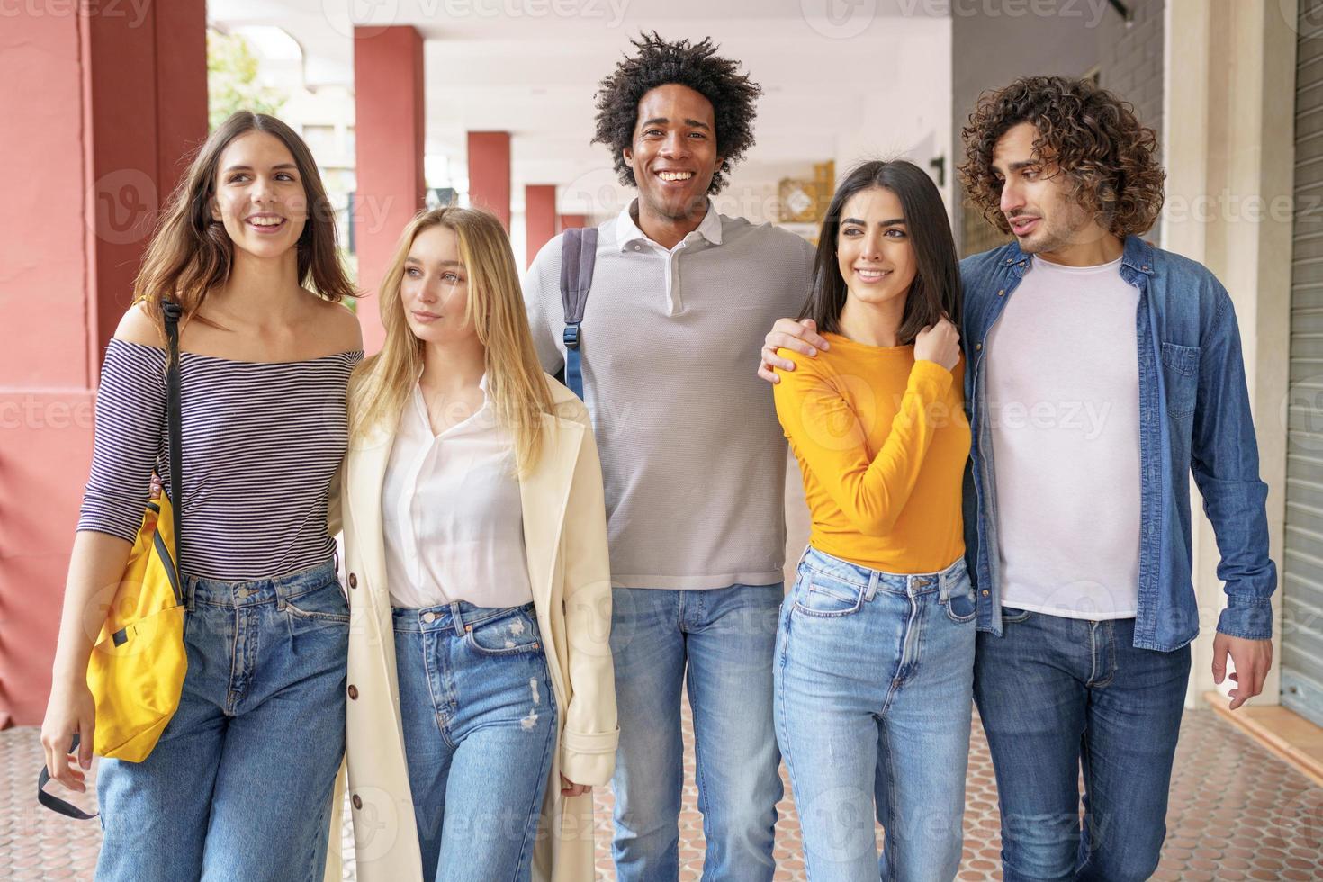 Multi-ethnic group of friends walking together on the street. photo