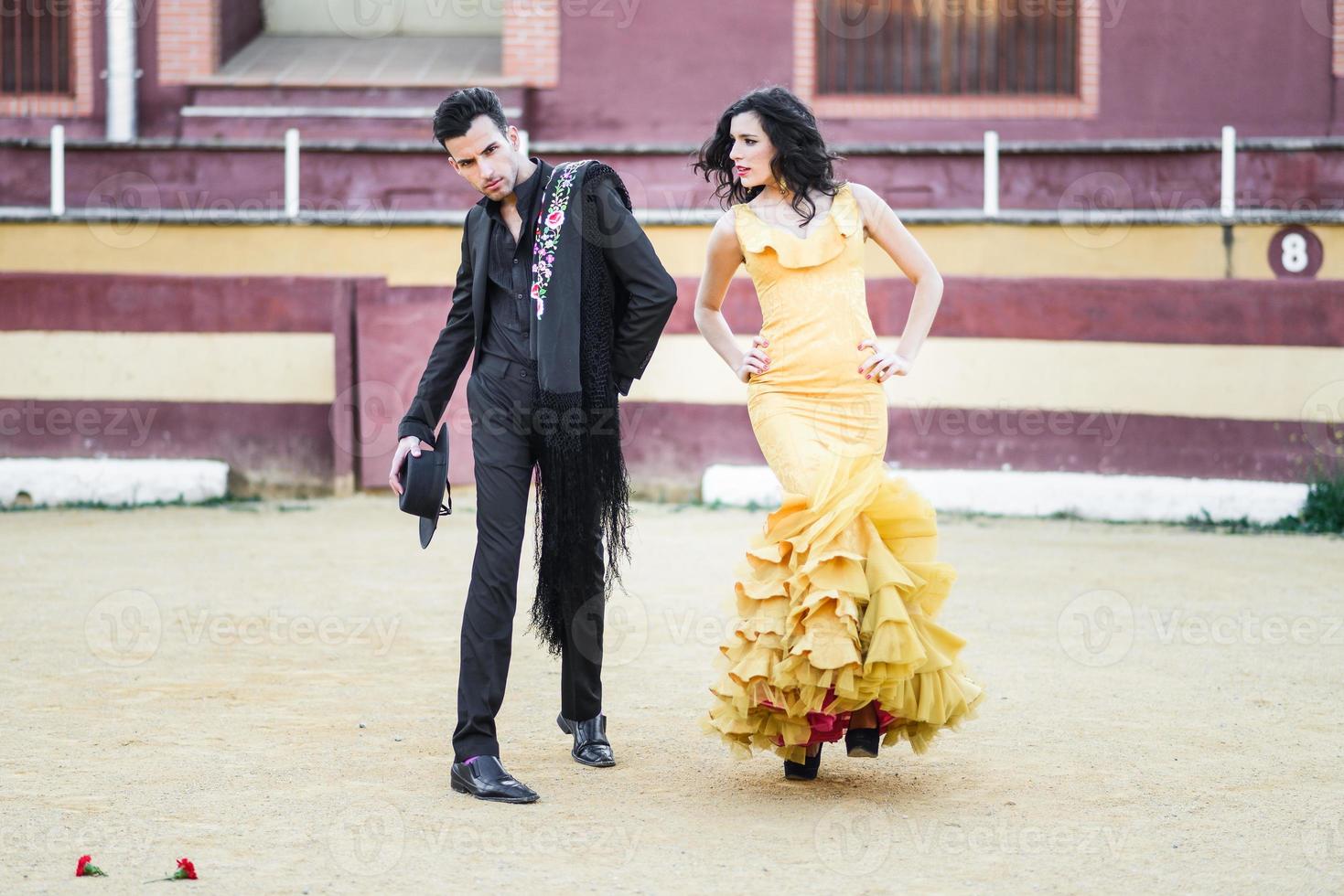 Couple, models of fashion, in a bullring photo