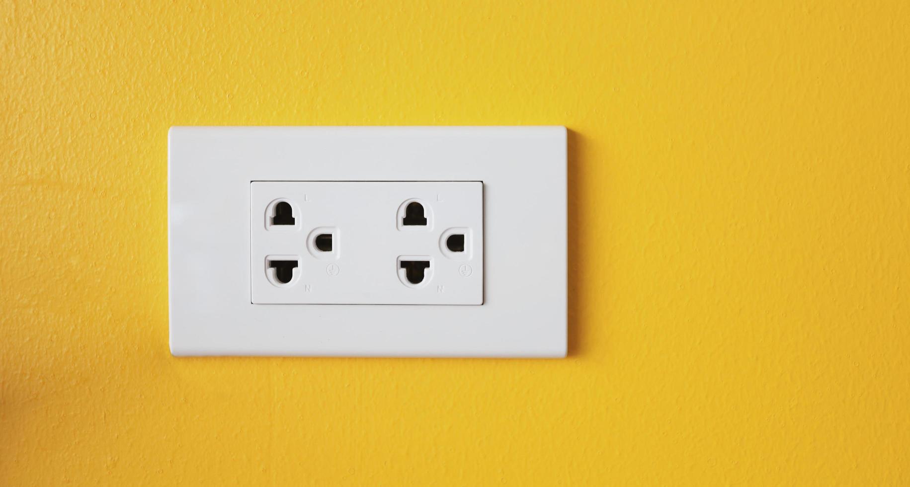The power sockets on the walls are painted in bright yellow. photo