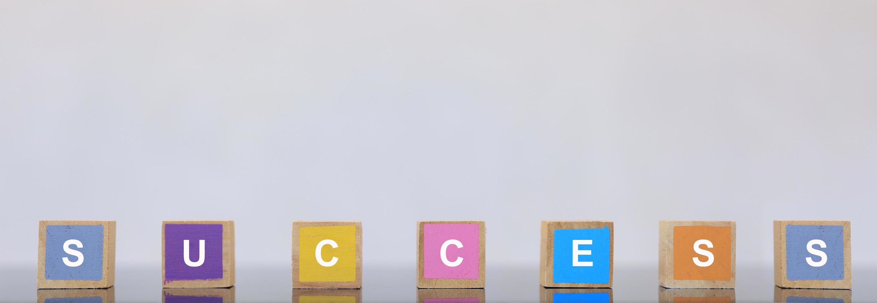 Wooden blocks of various colors have letters. The concept of successful people photo