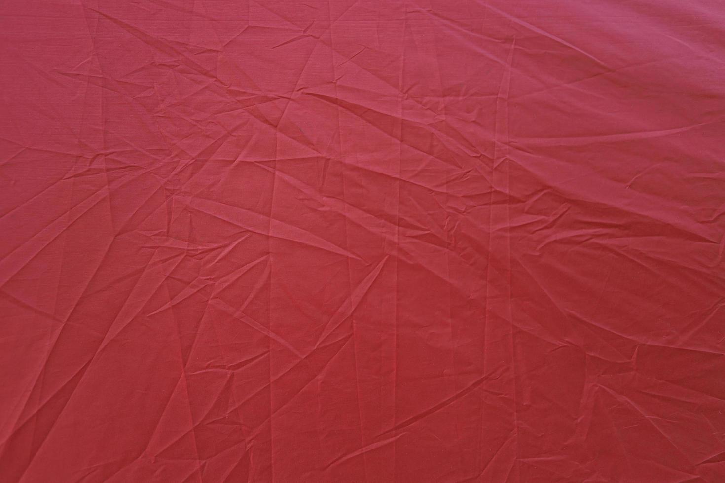 Wrinkled red canvas. Red textured background. Red canvas abstract background photo