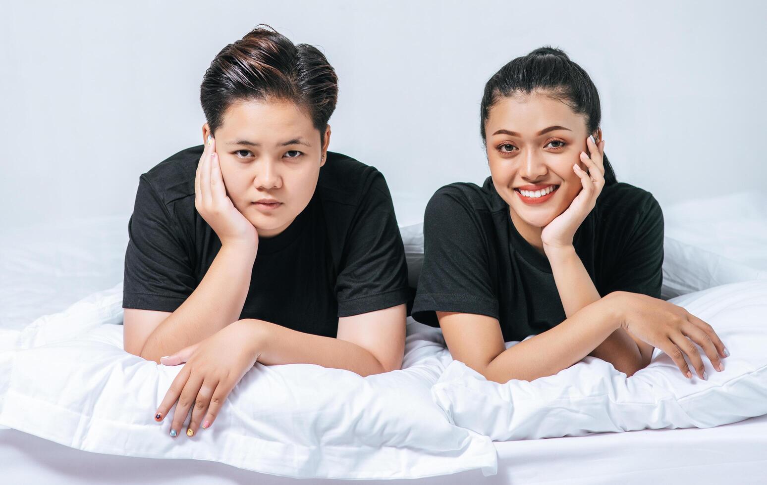 Two beloved young women slept in bed together. photo