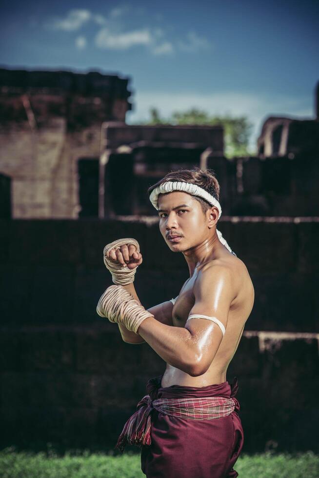 A boxer tied a rope in his hand and performed a fight, The martial arts of Muay Thai. photo