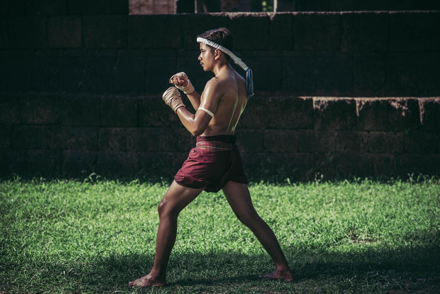 A boxer tied a rope in his hand and performed a fight, The martial arts of Muay Thai. photo