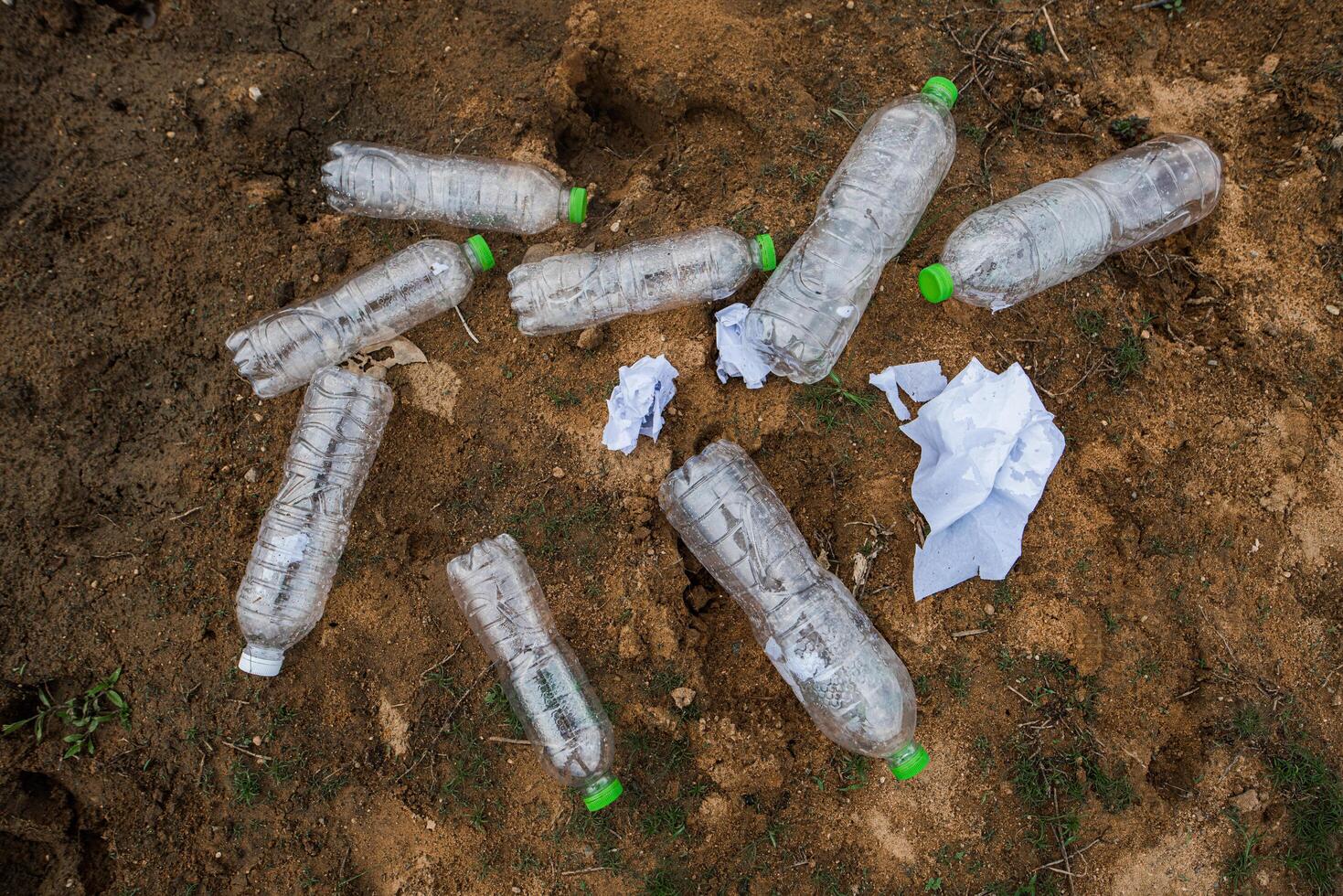 A lot of water bottles are on the floor. photo