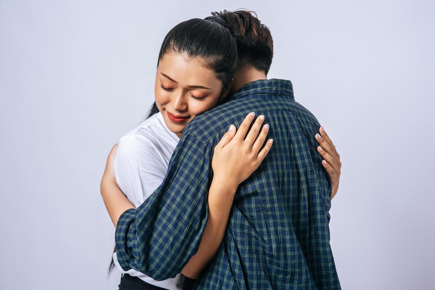 Two female couples standing and hugging each other. photo