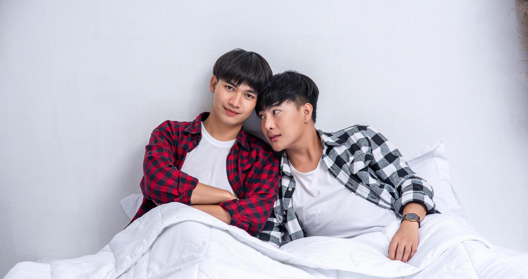 Two beloved young men slept in bed together. photo