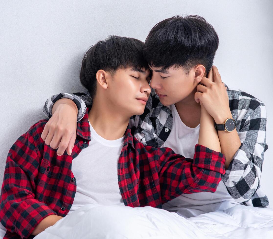 Two beloved young men slept in bed together. photo