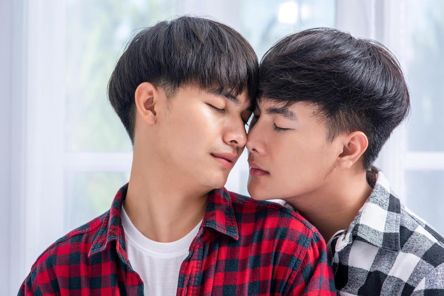 Two men who love each other hug from behind another. photo