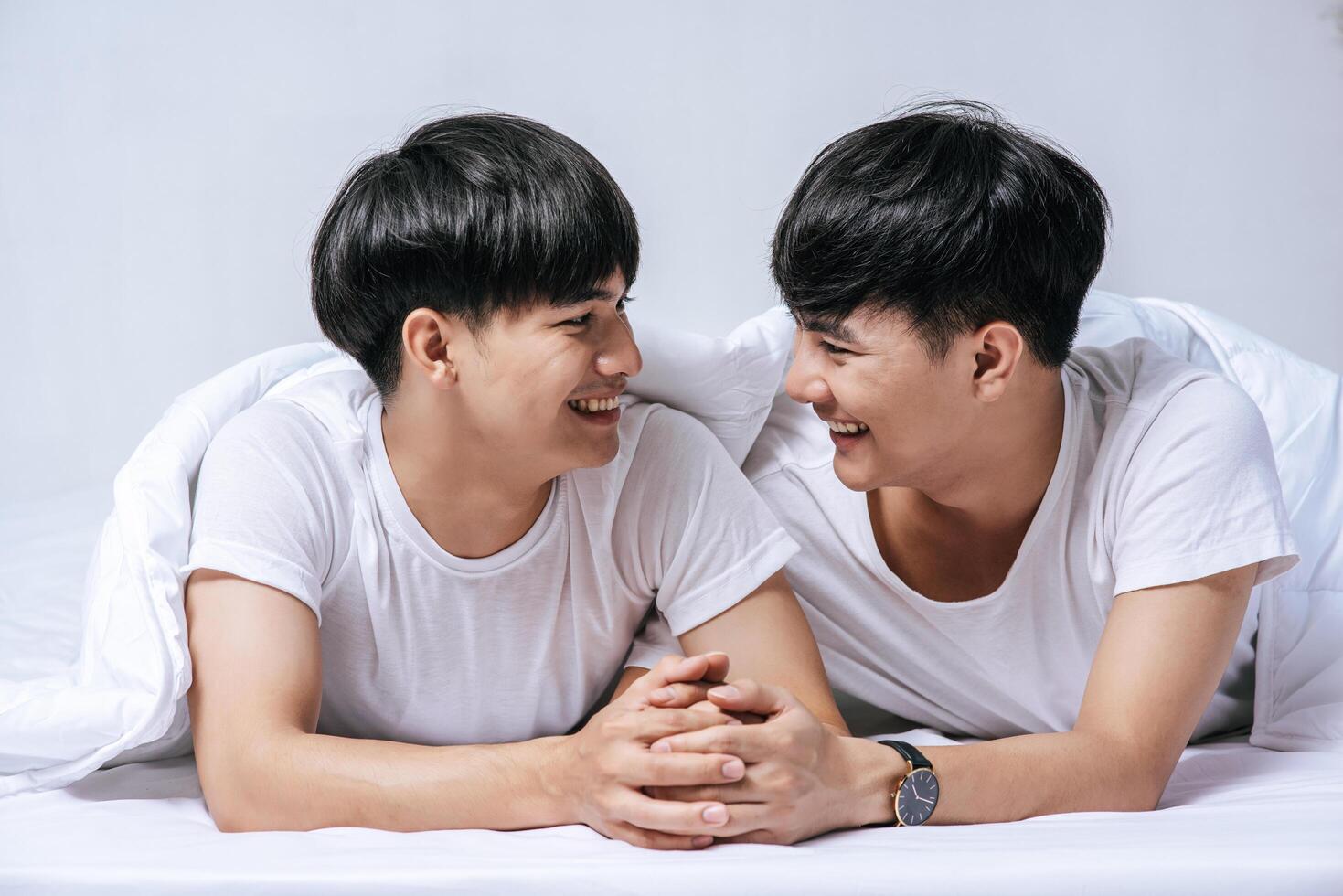 Two beloved young men slept in bed together. photo