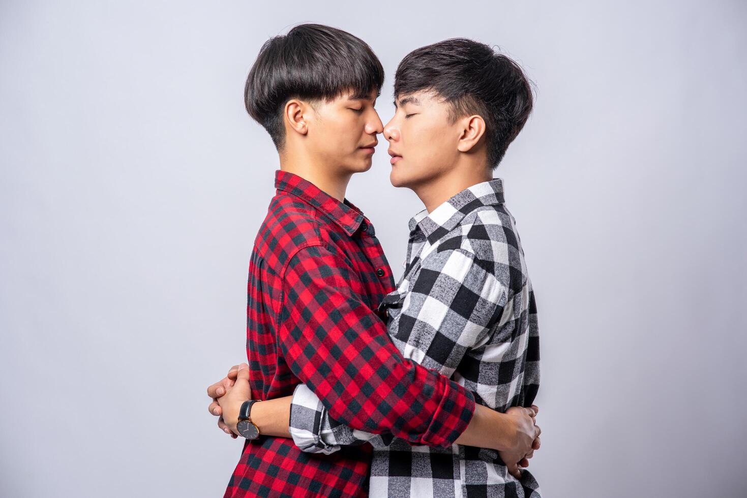 Two men who love each other happily hug each other. photo